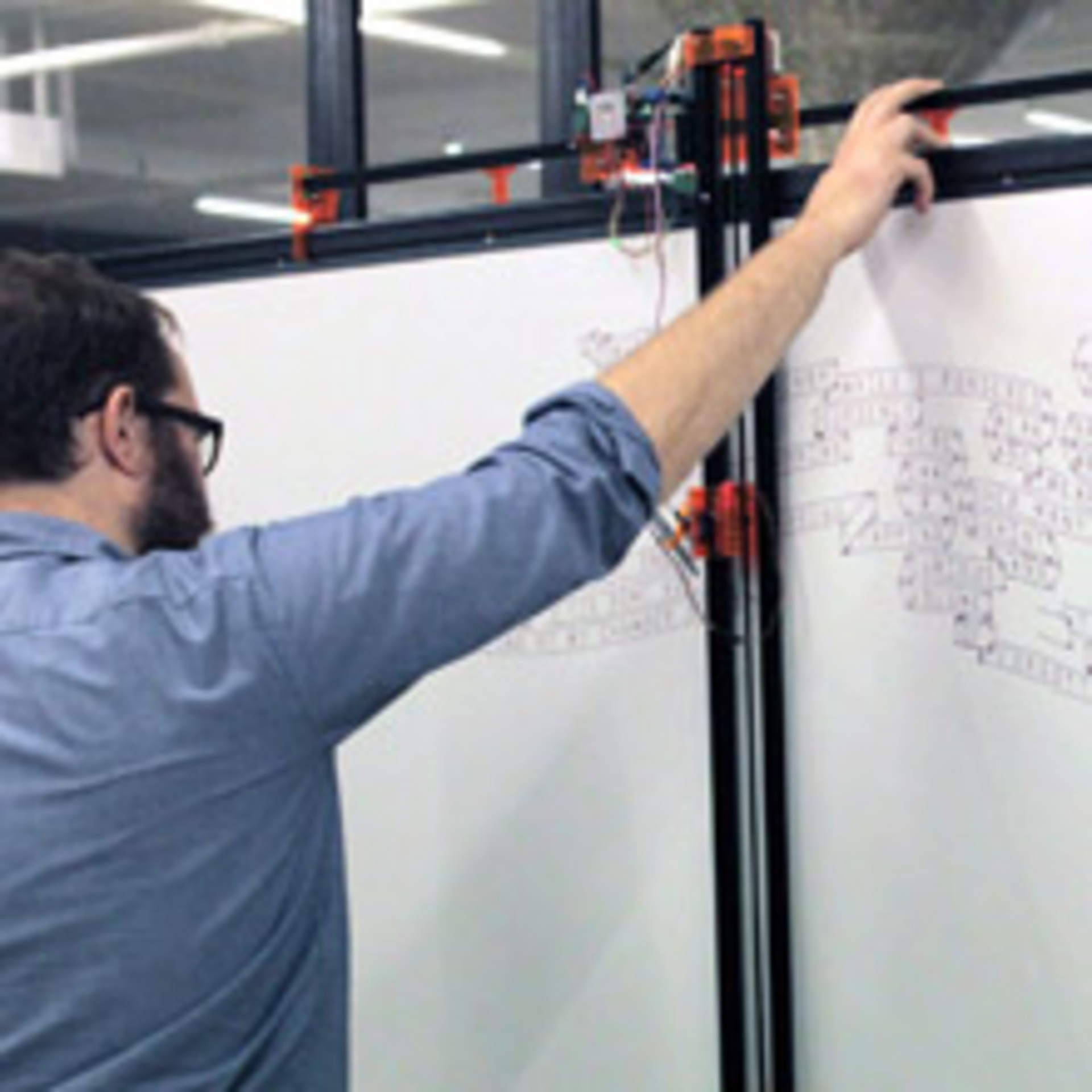 Greg holds the drawbot steady.